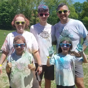 Happy family after participating in a fun paint event